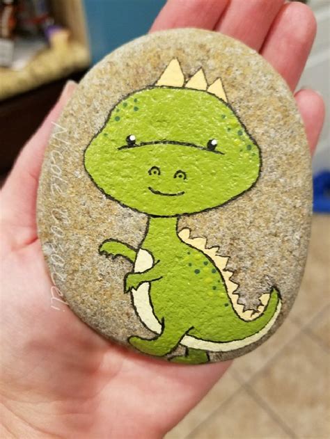 Dinosaur painted rock #paintedrocks #kindnessrocks | Rock painting art, Rock crafts, Painted rocks