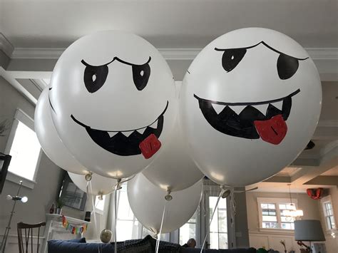 Boo Balloons for Super Mario Party. I inflated several white, 18 inch balloons and used sharpie ...