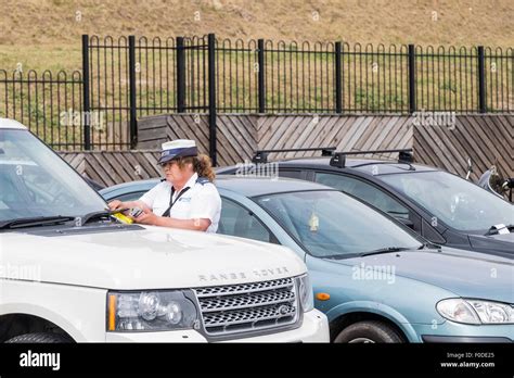 A Traffic Warden issuing a parking ticket on Southend seafront in Essex Stock Photo - Alamy