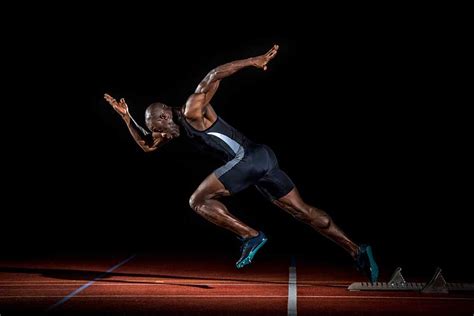 a man running on a track in the dark