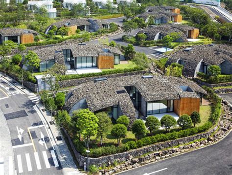 Volcanic Rock Tops Kengo Kuma's Curved Block D Condos on Jeju Island in South Korea