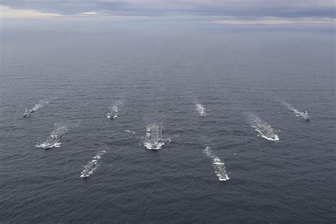 HMS Queen Elizabeth leading her Carrier Strike Group last year. The ...