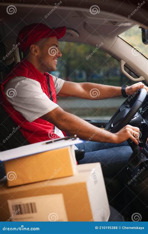 Courier in Uniform on Driver`s Seat of Car Stock Photo - Image of deliveryman, mail: 210195388