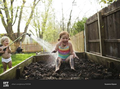 Children playing in mud - Offset stock photo - OFFSET