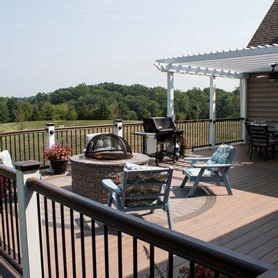 Wolf Amberwood decking with Black Walnut border. Paver inlay with fire pit. Fire Pit Pergola ...