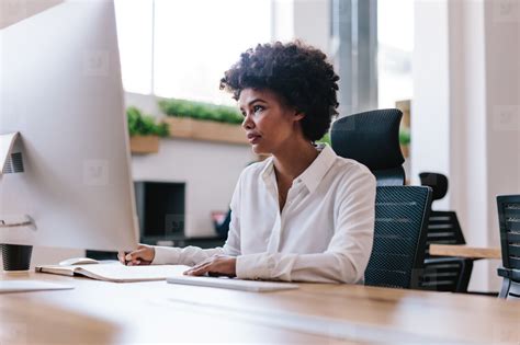 African woman working at her office desk stock photo (154804) - YouWorkForThem