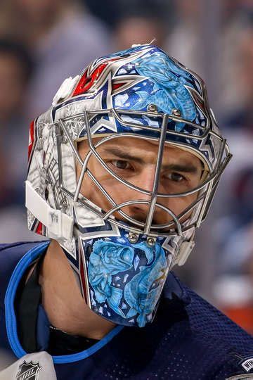 WINNIPEG, MB - DECEMBER 9: Goaltender Connor Hellebuyck #37 of the Winnipeg Jets looks on during ...