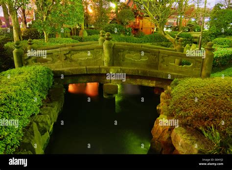 Japanese garden by night with traditional bridge o Stock Photo - Alamy