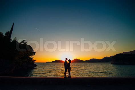 Silhouettes at sunset on the beach | Stock image | Colourbox