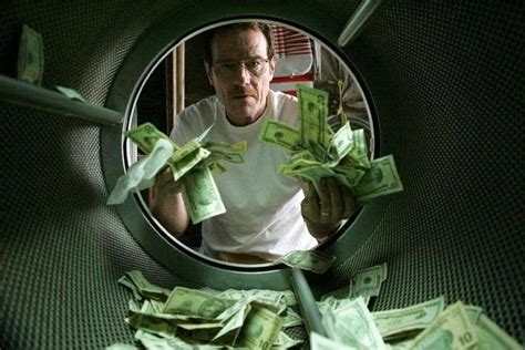 This image released by AMC shows Bryan Cranston as Walter White laundering money in the pilot ...