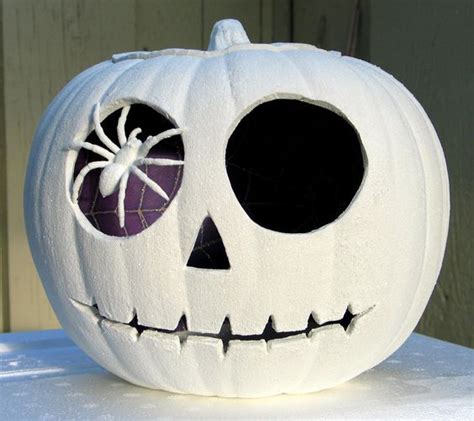 A very simple pumpkin with a craft store spider pinned into its 'eye ...