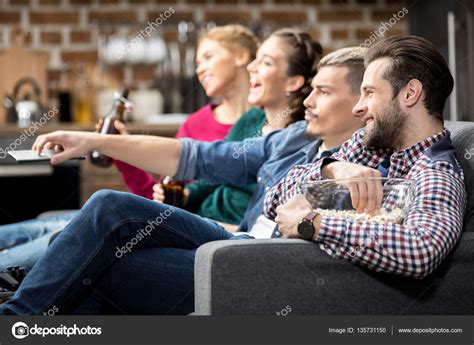 Friends watching tv — Stock Photo © AndreyBezuglov #135731150