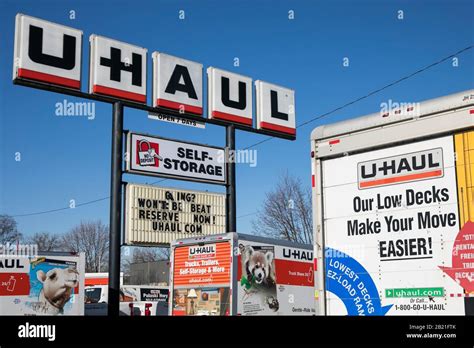 A logo sign and moving trucks outside of a U-Haul location in Baltimore ...