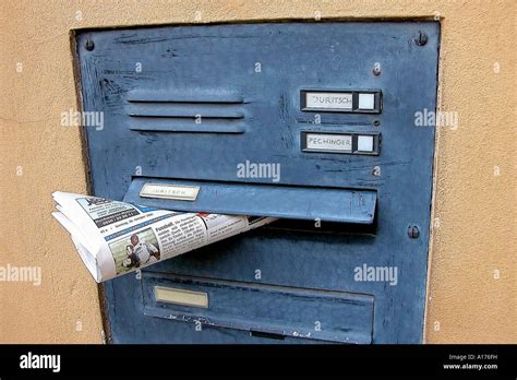Newspaper in a private letter box Stock Photo - Alamy