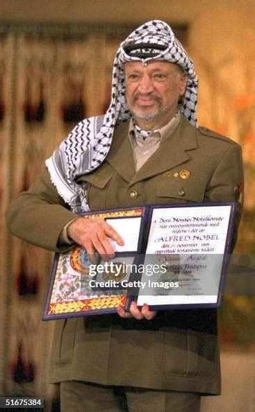 Palestinian leader Yasser Arafat displays his Nobel Peace Prize... News Photo - Getty Images