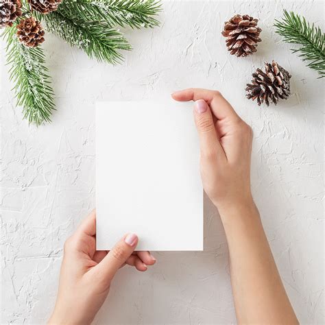 Free Christmas Card Mockup in Hands | Mockup World HQ