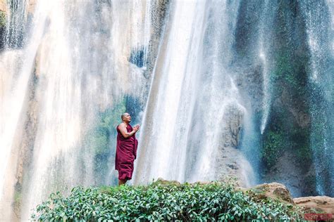 - Buddhist monk praying under big waterfall, Myanmar | Royalty Free Image