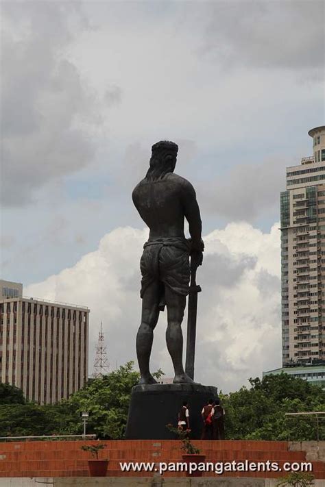 Lapu-lapu monument side view with clouds and flowers deside the ...