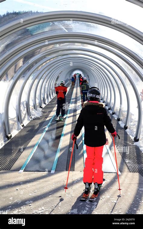 Skiers on a covered magic carpet on the learner's slope aka Bunny slope ...