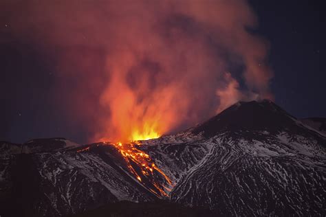 In Catania, Italy, snow-covered Mount Etna, Europe's most active volcano, spews lava during an ...