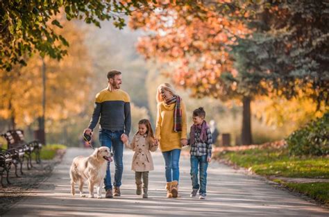 a family walking down the street with their dog