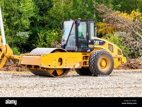 Heavy bulldozer loading and moving gravel on road construction site ...