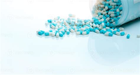 Blue-white antibiotic capsule pill and capsule pills bottle. Antibiotic drug resistance ...