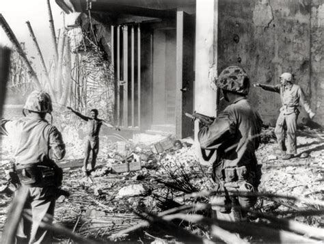 A Japanese soldier surrendering to three U.S. Marines in the Marshall ...