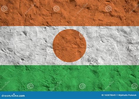 Niger Flag Depicted in Bright Paint Colors on Old Relief Plastering Wall. Textured Banner on ...