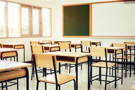 Premium Photo | Empty school classroom with desks chair wood, green board and whiteboard in high ...