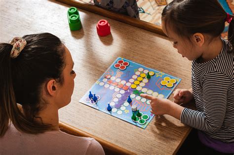 Family Playing Board Game At Home Stock Photo - Download Image Now - iStock