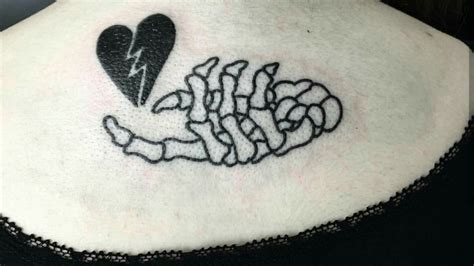 Skeleton Hand Holding Heart Tattoo