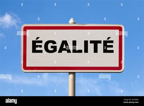 A French entry city sign against a blue sky with written in the middle in French "Égalité ...