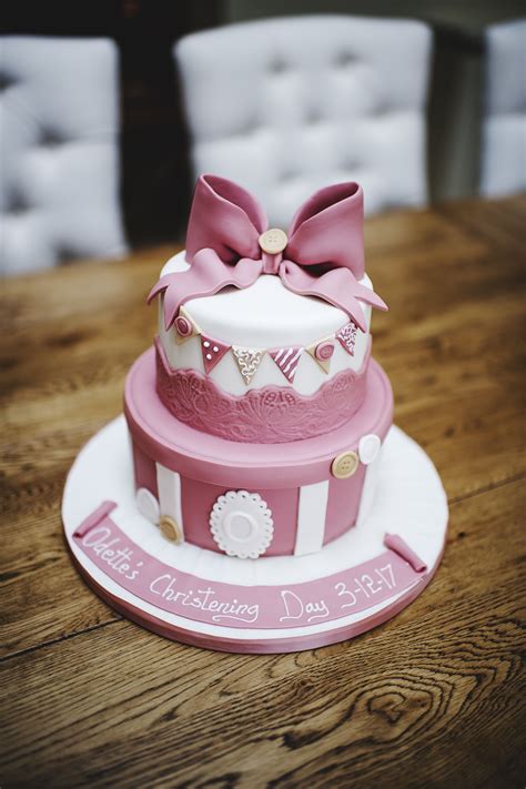 Christening Cake for baby girl. Classic, pink with a bow on top. 2 tiered chocolate biscui ...