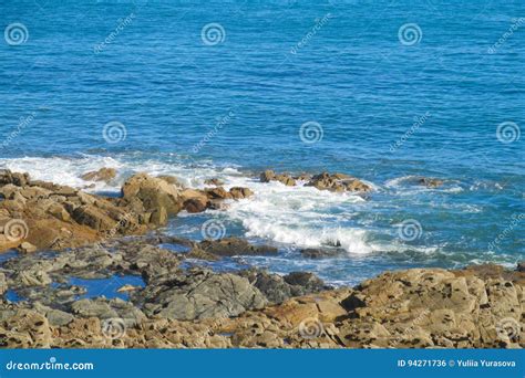 Sea tide waves on rocks stock photo. Image of sunlight - 94271736