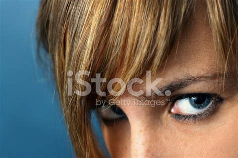 Portrait Of Young Woman's Eyes Glaring, On Blue Background Stock Photo ...