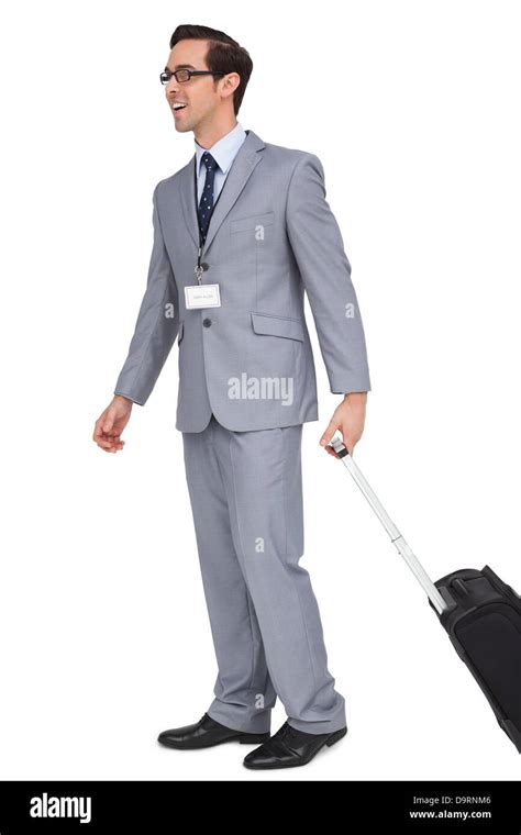 Smiling businessman walking with his suitcase Stock Photo - Alamy