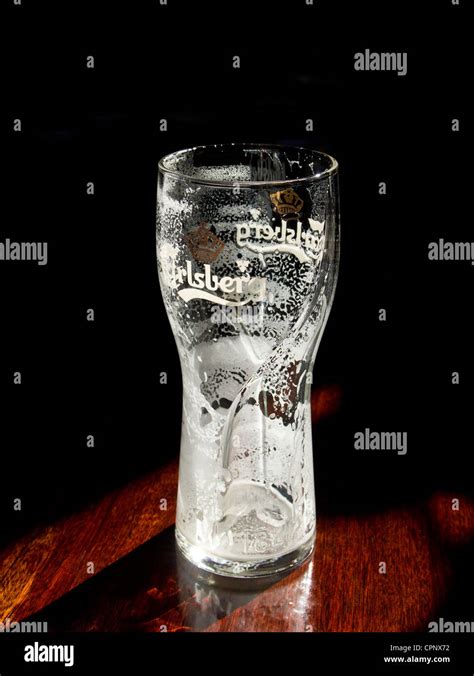 Empty beer glass - Carlsberg lager pint glass Stock Photo - Alamy