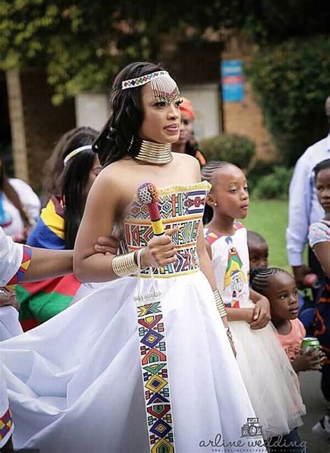 Ndebele Attire - Ndebele women in tribal dress outside a traditionally ...