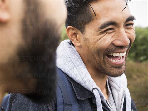 Close up of two smiling young men. stock photo