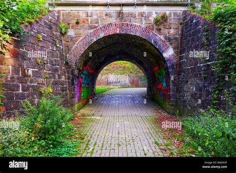 Dark Tunnel with lots of Graffiti beneath an abandoned Train Track Stock Photo - Alamy