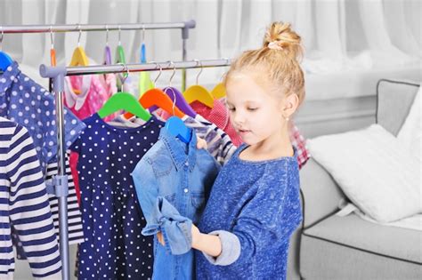 Premium Photo | Little girl trying on a new jeans tshirt