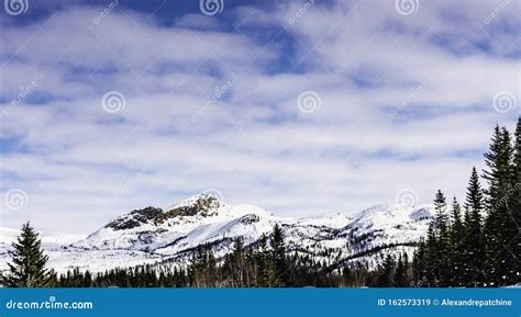 Scandinavian Mountain Range Covered by Ice and Snow, Frozen Lake, Blue Skies, Pine Forest Stock ...