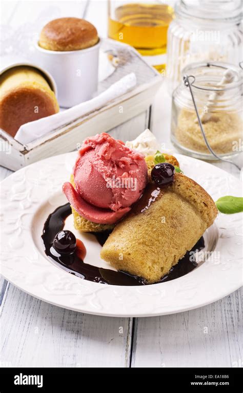 Rum baba with ice cream Stock Photo - Alamy