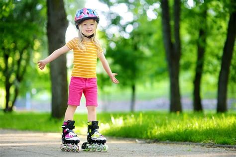 Girl learning to roller skate Stock Photo by ©MNStudio 145516065