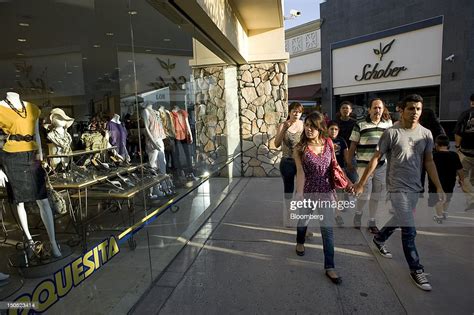 People walk through the Plaza Rio Tijuana shopping mall in Tijuana ...