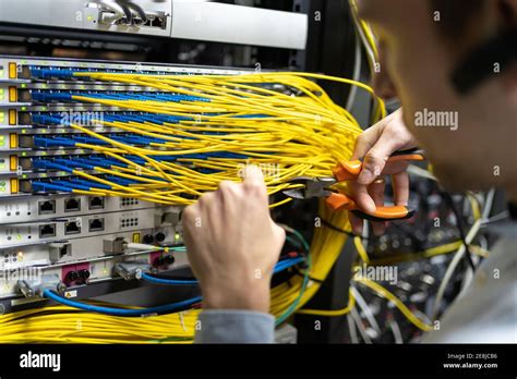 Crop male technician with wire cutters working with electronic system of server room Stock Photo ...