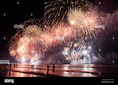 New Year on the beach. Celebrating with exploding colorful fireworks Stock Photo - Alamy