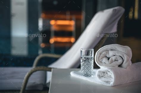 Spa background with a glass of water and towels in a spa complex. Stock Photo by puhimec