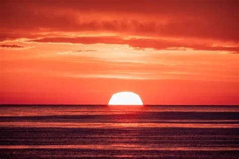 Beautiful red and orange sunset over the sea. The sun goes down over the sea. - Stock Image ...